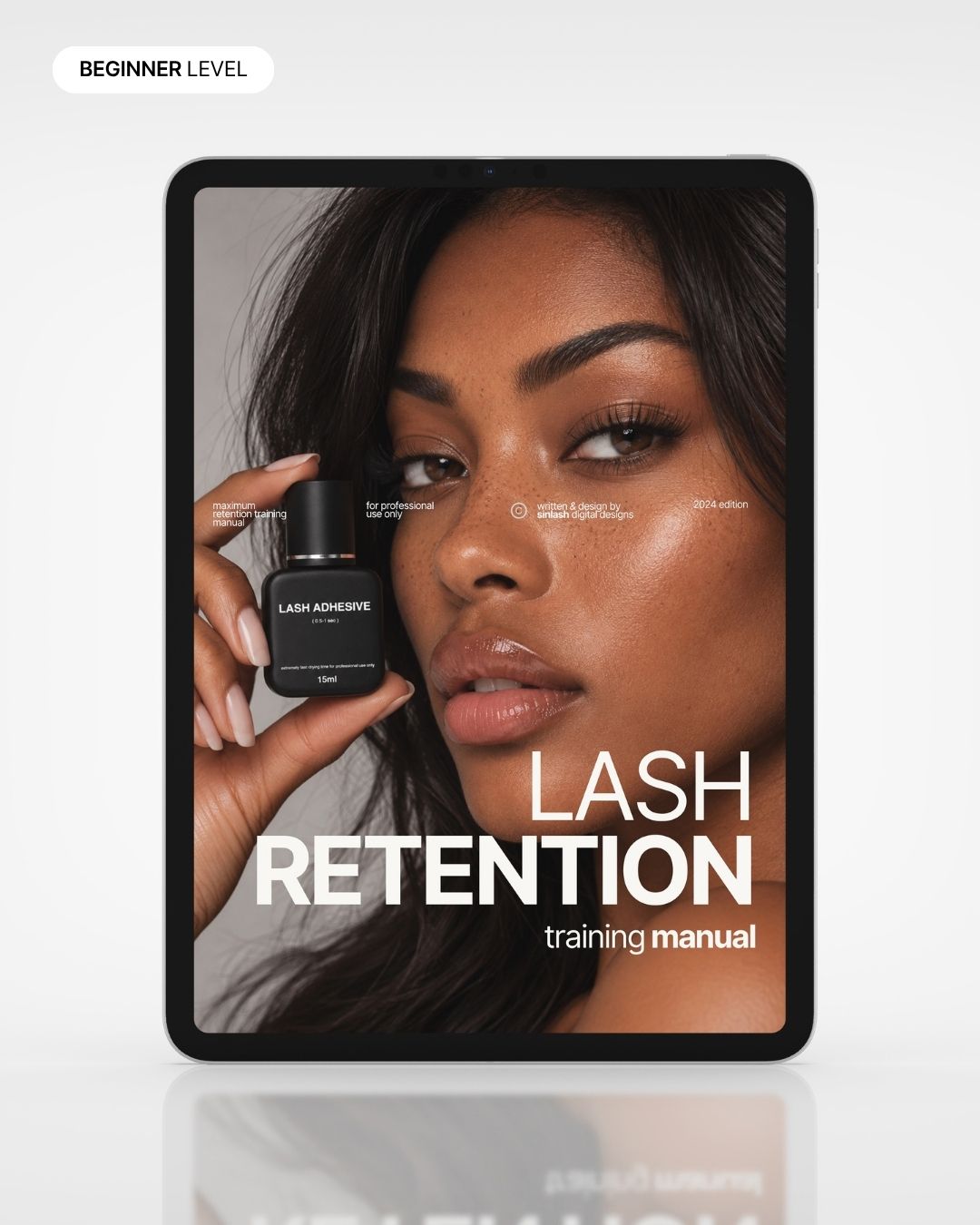 Lash Retention training manual cover on a tablet, held by a model with lash adhesive